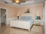 The master bedroom has a king sized bed and beach decor